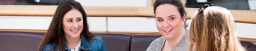 Three students sat together talking